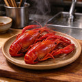 Cooked red crawfish piled on a ceramic plate