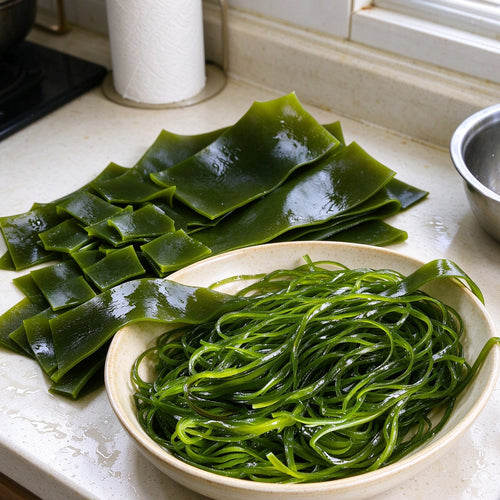 Fresh kelp sheets, tied knots and fine shreds on a plate